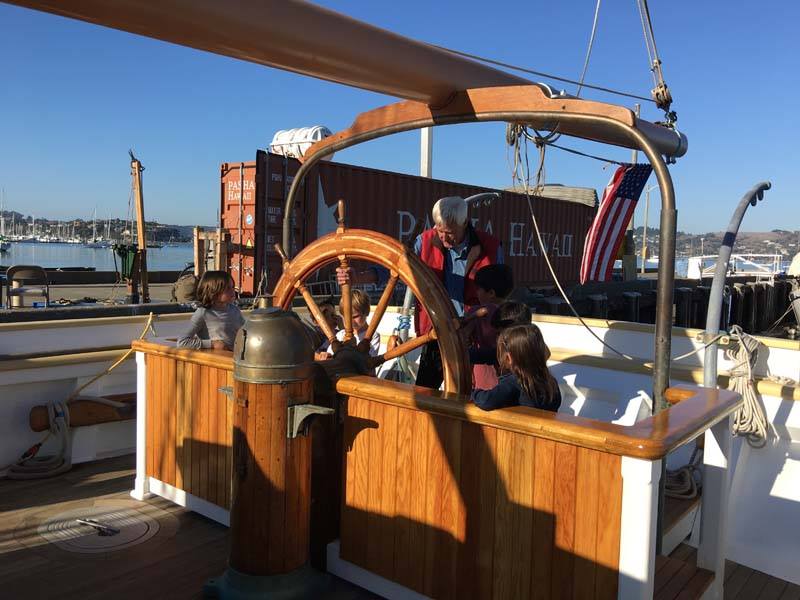 Alan at the helm with youth visitors