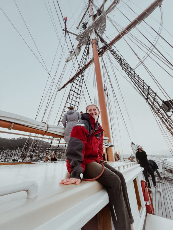 Catherine Crow Volunteer Catherine Crow relaxing on the cabin top on Matthew Turner, after helping furl sails.